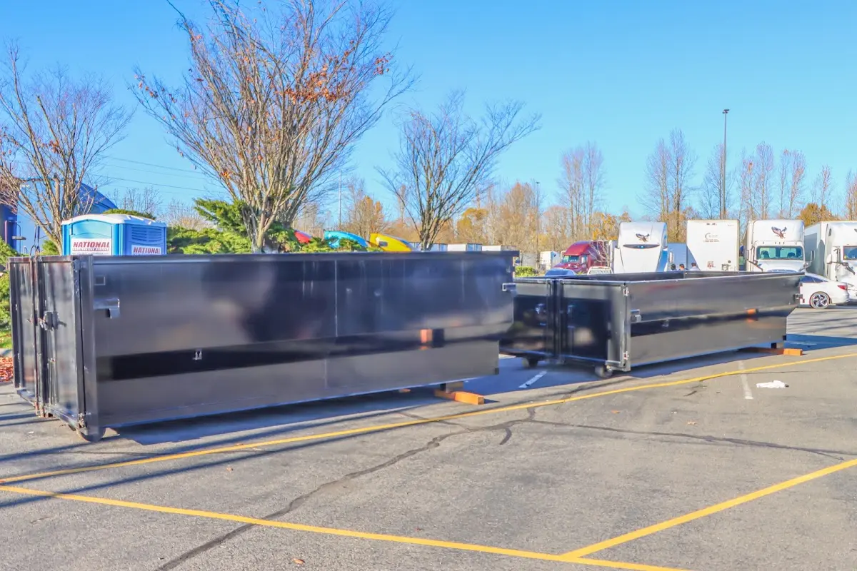 Professional dumpster rental service with roll-off container on residential driveway in Dixon